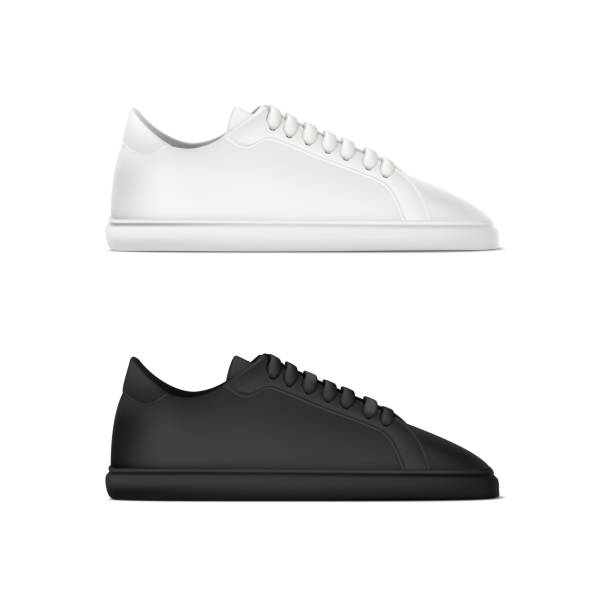 istock realistic vector icon. Set of running sneakers shoes in white and black color. Side view. 1440663069