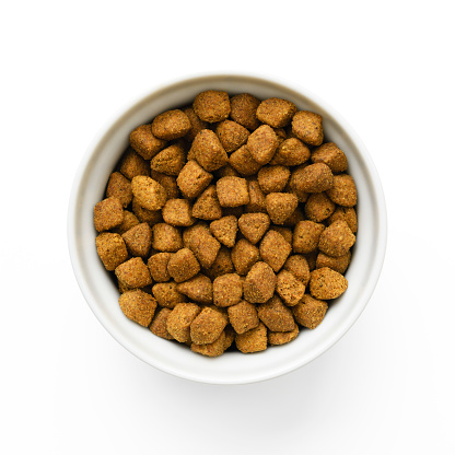 Overhead shot of bowl full of dry food for cats, isolated on white with clipping path.
