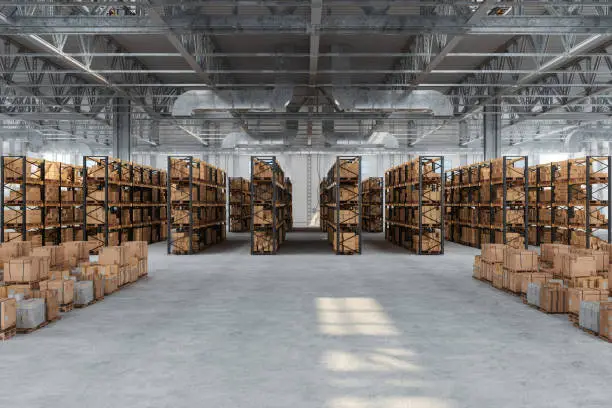 Photo of Distribution Warehouse With Cardboard Boxes On The Racks And On The Floor