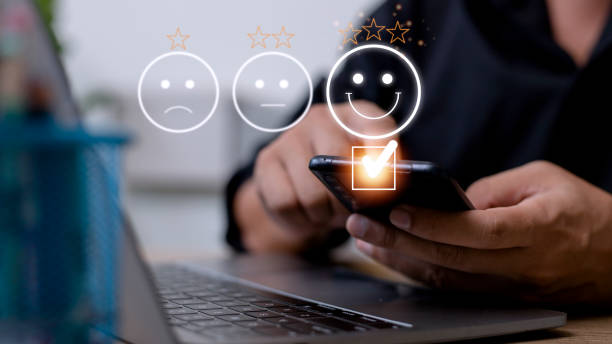 istock Customer service evaluation concept. using a smartphone is pressing face emoticon smiling in satisfaction on virtual touch screen. 1440671268