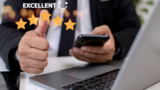 customer hand  with gold five star rating feedback icon and press level excellent rank for giving best score point to review the service, business concept