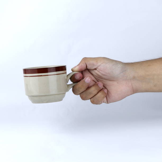 istock hand holding a glass of cup on a white background 1440674548