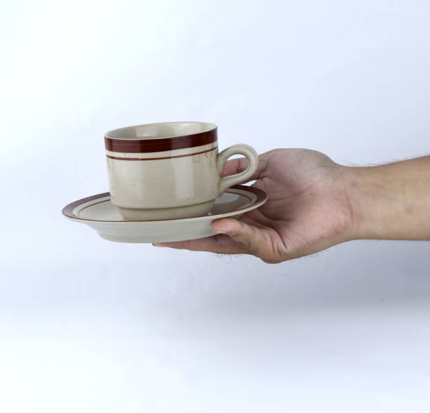 istock hand holding a glass of cup on a white background 1440674843
