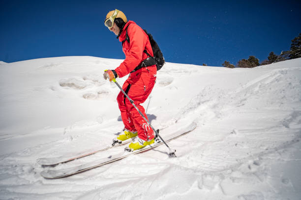 istock Young adult man skiing in mountains 1440678545
