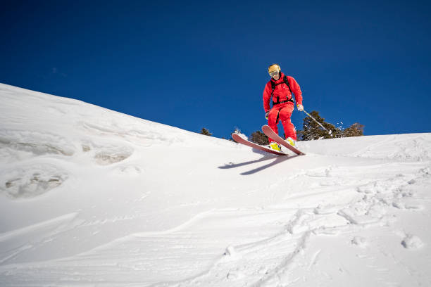istock Young adult man skiing in mountains 1440678581