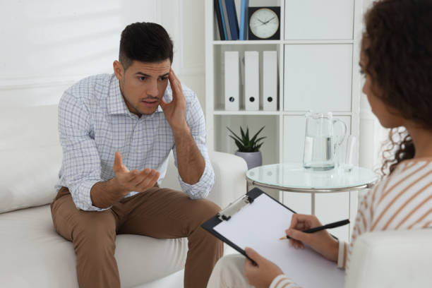 istock Unhappy man having session with his therapist indoors 1440679862