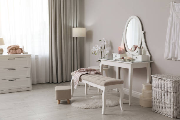 istock Wooden dressing table with decorative elements and makeup products in room. Interior design 1440680450