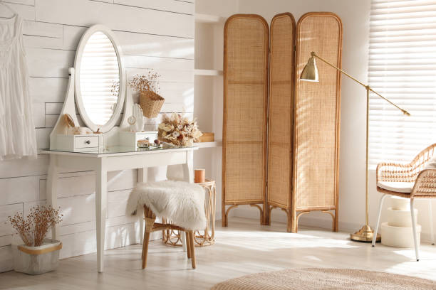 istock Wooden dressing table with decorative elements and makeup products in room. Interior design 1440680492