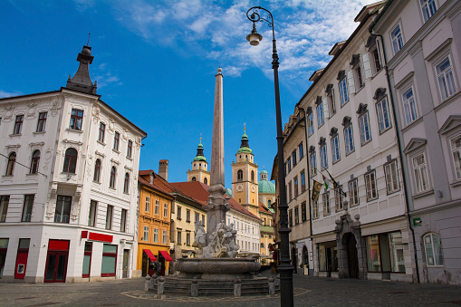Robba Fountain in Town Square or Mestni Trg in central Ljubljana. Called Robbov Vodnjak in Slovenian, it is also known as the Fountain of the Three Carniolan Rivers. Ljubljana Cathedral is in the background