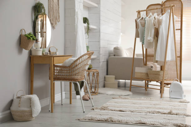 istock Rack with stylish women's clothes and dressing table in room. Interior design 1440681524