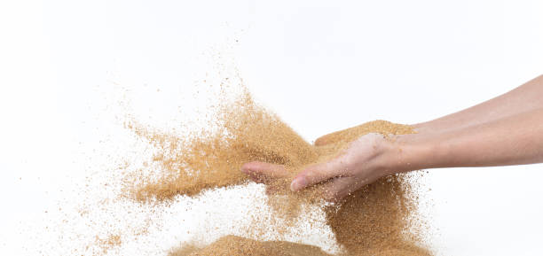 istock Sand flying explosion, Golden sand wave explode. Abstract sands cloud fly. Yellow colored sand splash throwing in Air. White background Isolated high speed shutter, throwing freeze stop motion 1440681586