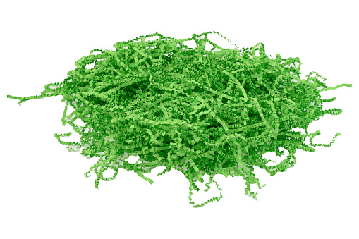 green confetti shredded crinkled paper for gifts and stuffing in cardboard boxes.Isolated white background