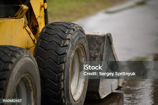 istock Wheeled bulldozer close-up. Rear view of the wheel and bucket. 1440682457