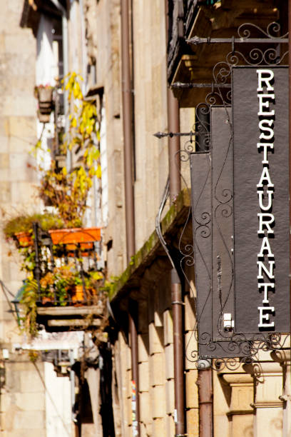 istock Restaurant cast iron sign on building facade, stone facades in the background. 1440682593