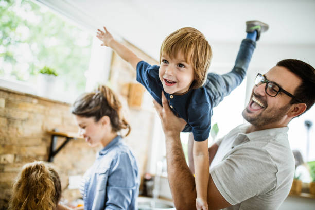 istock Happy boy having fun with his father in the kitchen. 1440682958
