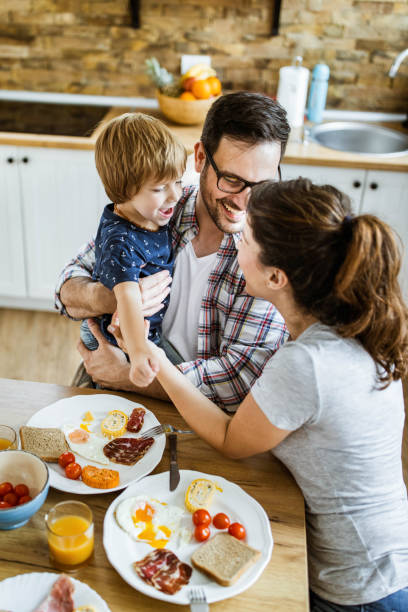 istock Happy family having fun during breakfast in dining room. 1440682969