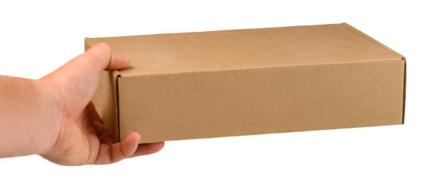 istock cardboard box in a man's hand on a white isolated background. 1440683929