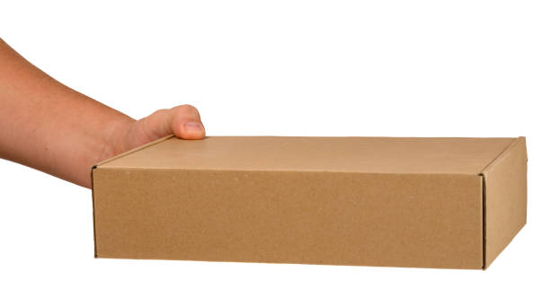 istock cardboard box in a man's hand on a white isolated background. 1440683981