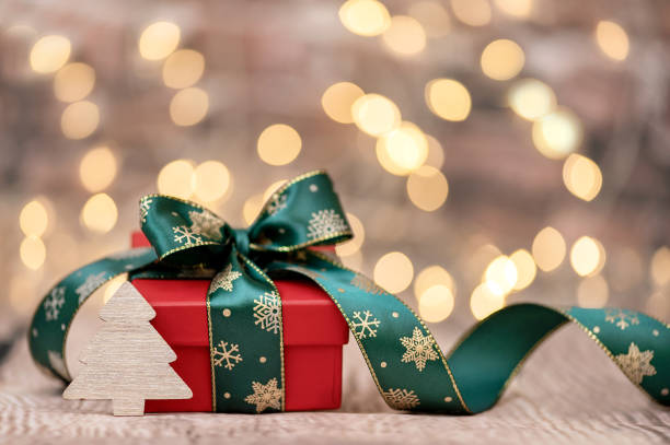 istock Christmas or New Year background. Wooden Christmas tree with a gift box 1440684085