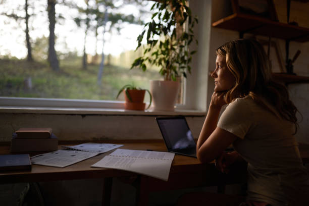 istock Pensive casual woman taking a break at home office. 1440685618