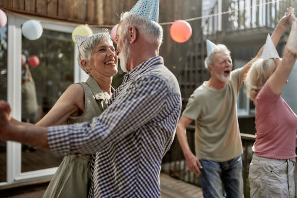 istock Happy senior couples dancing during a Birthday party on a terrace. 1440685928