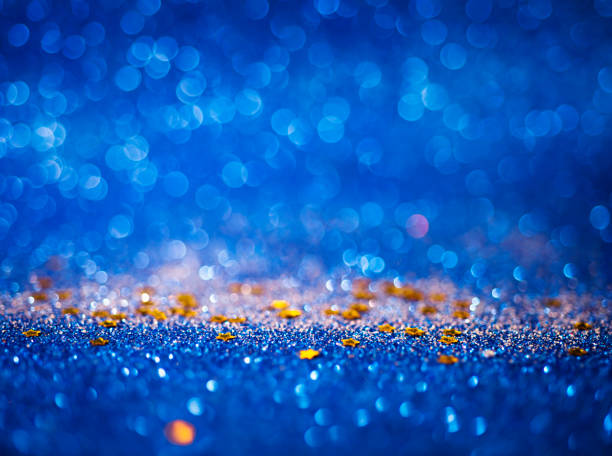 istock Blue abstract glitter lights background with yellow stars 1440686194