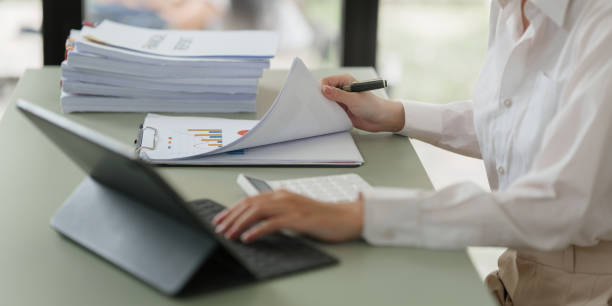 istock Pleasant positive business woman using digital tablet at home office 1440687430