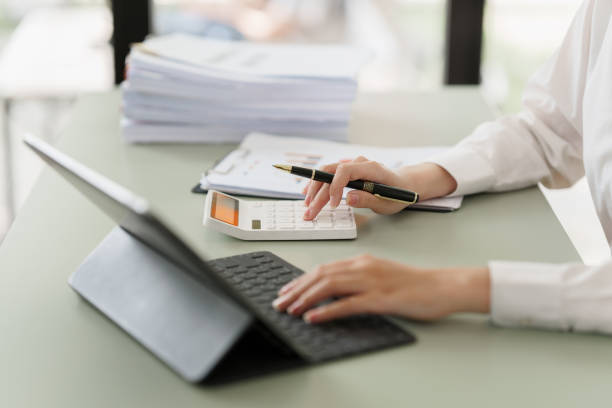 Pleasant positive business woman using digital tablet at home office