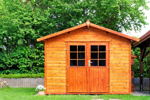 Frontal view of wooden garden shed Frontal view of wooden garden shed glased in teak color outdoor shed stock pictures, royalty-free photos & images