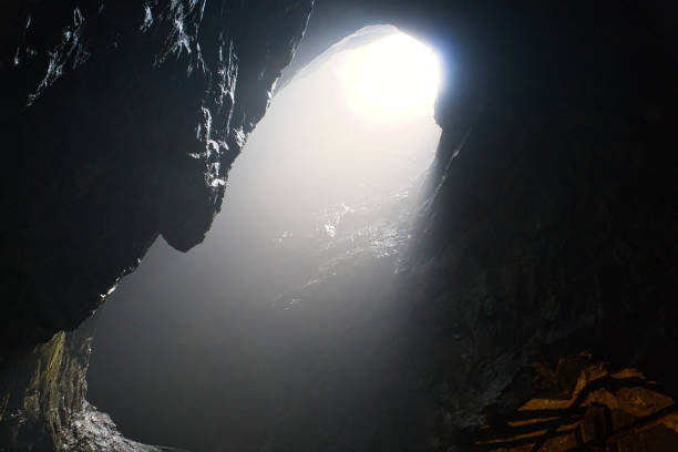 istock Rock cave with hole through which light shines. Underworlds in Sweden. Mystical 1440690473