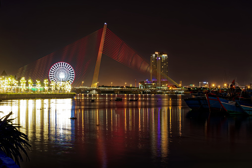 Illuminated Tran Thi Ly Bridge by night. Cable-stayed bridge spans the Han River in the city of Da Nang, Vietnam