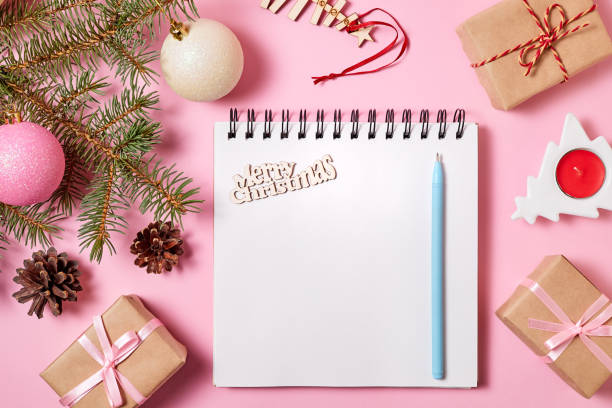 istock Blank notepad on pink background with christmas accessories 1440692595