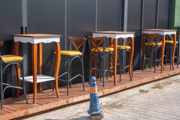 istock High tables and chairs along the wall outside. 1440696152