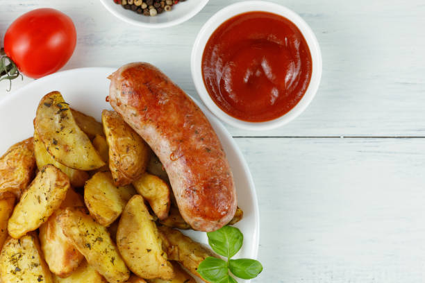 istock Grilled sausages with ketchup and potato 1440696218