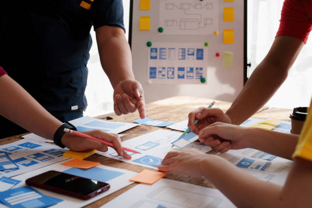 istock Group of ux developer and ui designer brainstorming about app interface design at modern office. Creative digital development agency. 1440698116