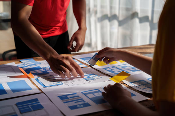 istock Group of ux developer and ui designer brainstorming about app interface design at modern office. Creative digital development agency. 1440698464
