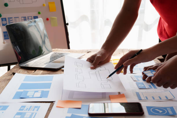 istock Group of ux developer and ui designer brainstorming about app interface design at modern office. Creative digital development agency. 1440699135