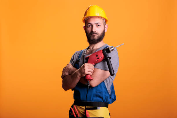 istock Happy building contractor holding power drill gun 1440699157