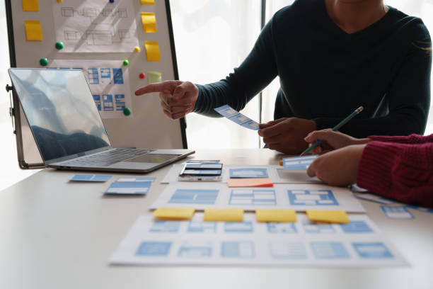 istock Group of ux developer and ui designer brainstorming about app interface design at modern office. Creative digital development agency. 1440699179