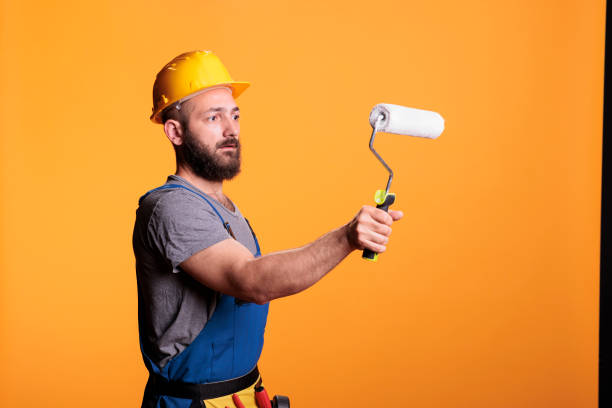 istock Professional handyman using rolling brush to do painting job 1440699375
