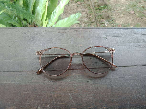 istock Glasses on a wooden plank in the park 1440700491