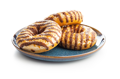 Donuts with chocolate and caramel icing isolated on the white background.