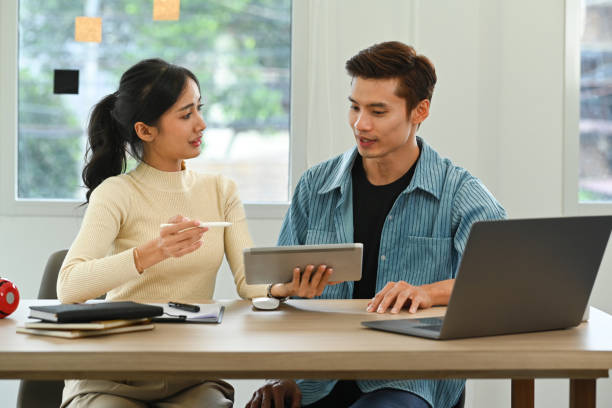 istock Image of young creative people discussing online information, sharing idea for new startup project in bright office. 1440700522