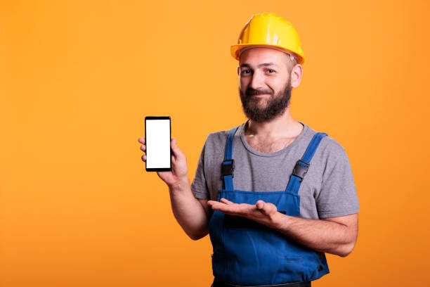 istock Caucasian worker presenting isolated phone 1440700805