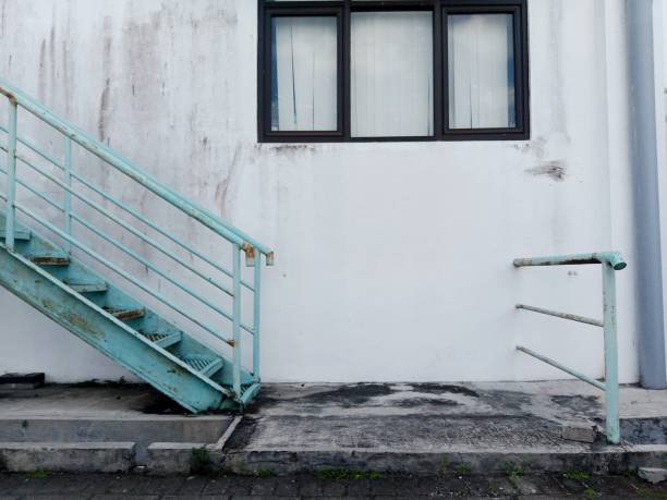istock white building walls with windows and iron stairs. 1440701127