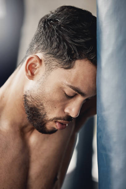 istock Tired, challenge and sad boxing man break, quit and training fatigue. Frustrated loser, stress fail and depression mma fighter breathing in gym club, wrestling athlete weakness and boxer combat sport 1440701129