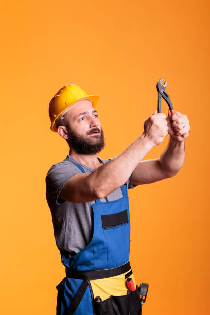 istock Young foreman builder looking focused at pair of pliers 1440701365