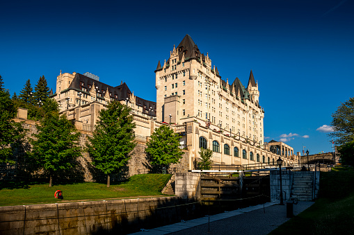 Ottawa, Canada - August 19, 2022: View to the Fairmont Chateau Laurier Hotel. Rideau canal in front. Ottawa is the capital city of Canada.