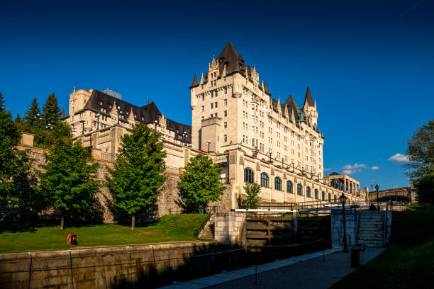 Fairmont Chateau Laurier Hotel in Ottawa in Canada Ottawa, Canada - August 19, 2022: View to the Fairmont Chateau Laurier Hotel. Rideau canal in front. Ottawa is the capital city of Canada. chateau laurier stock pictures, royalty-free photos & images