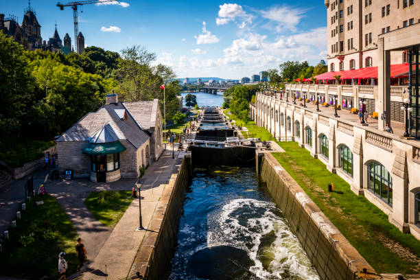 Ottawa, Canada - August 19, 2022: View along Rideau Canal with a length of 202km is a UNESCO world heritage site. Chateau Laurier Hotel on right side. Ottawa is the capital city of Canada.